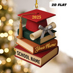 May include: A graduation-themed ornament featuring a red mortarboard with "2025" in gold, atop a stack of books and a diploma. The books are in various colors, with "SCHOOL NAME" and "Your Name&