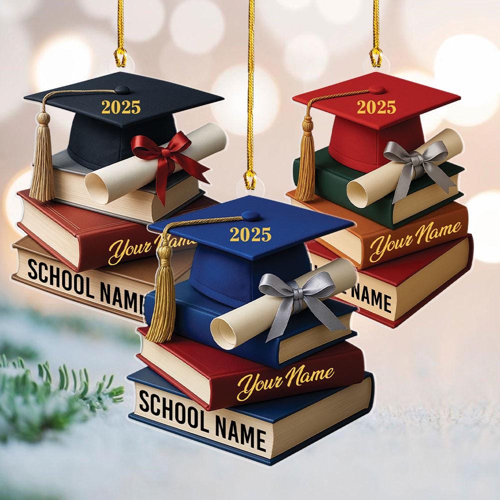 May include: Graduation-themed ornaments featuring a graduation cap with the year 2025, a diploma, and a stack of books. The ornaments are in navy blue, red, and blue, with gold tassels and ribbons. The books have the te
