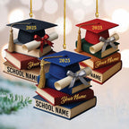 May include: Graduation-themed ornaments featuring a graduation cap with the year 2025, a diploma, and a stack of books. The ornaments are in navy blue, red, and blue, with gold tassels and ribbons. The books have the te