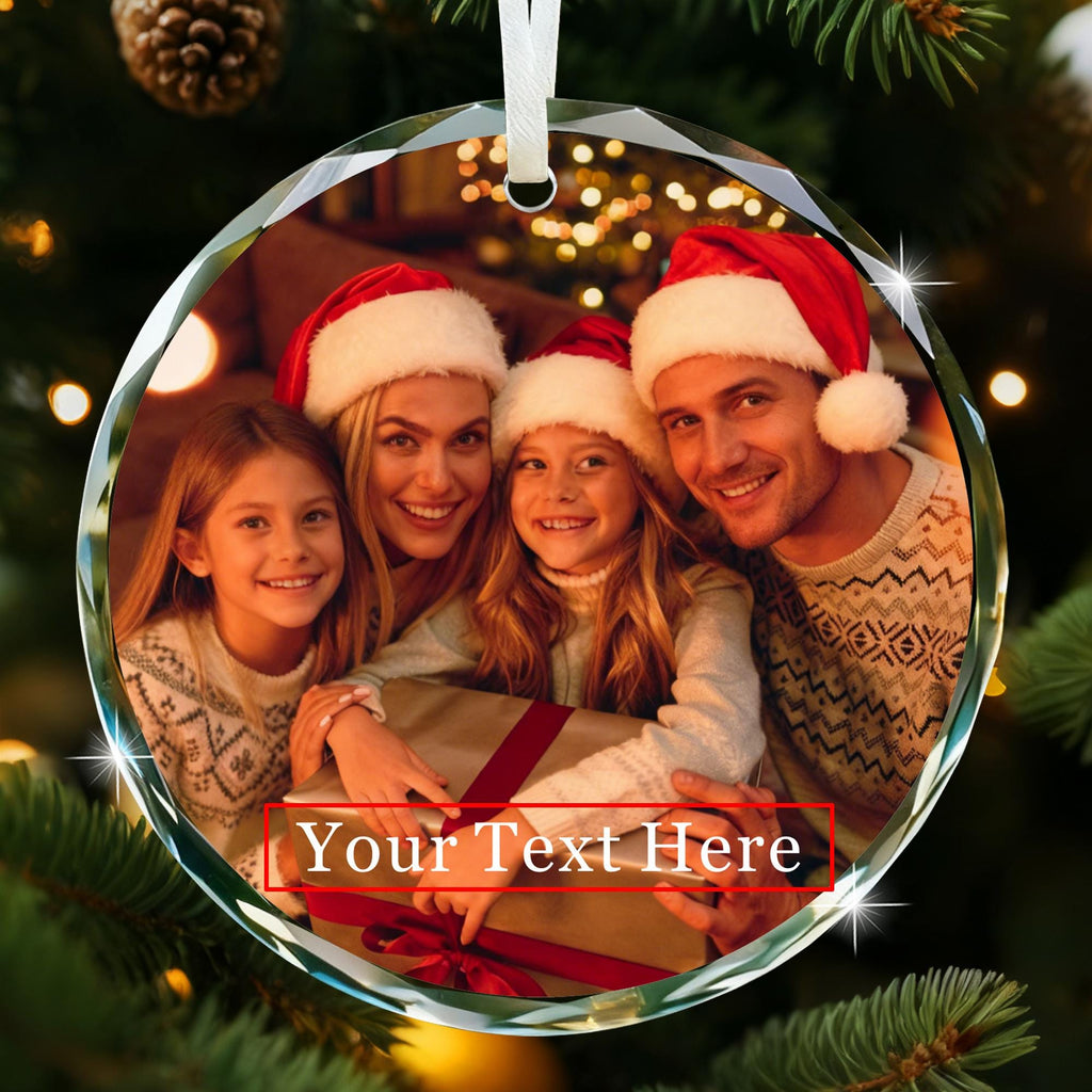 May include: A round, clear glass Christmas ornament with a family photo inside. The family is wearing Santa hats and smiling. The ornament has the text "Your Text Here" on the bottom. A white ribbon is attache